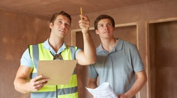 Builder And Inspector Looking At New Property
